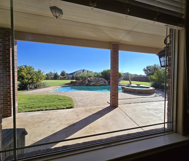 view of patio / terrace featuring a swimming pool with hot tub