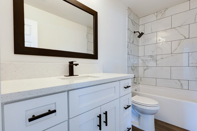full bath with toilet, vanity, wood finished floors, and bathing tub / shower combination