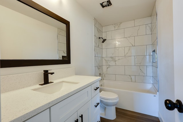 full bath with wood finished floors, toilet, vanity, and  shower combination