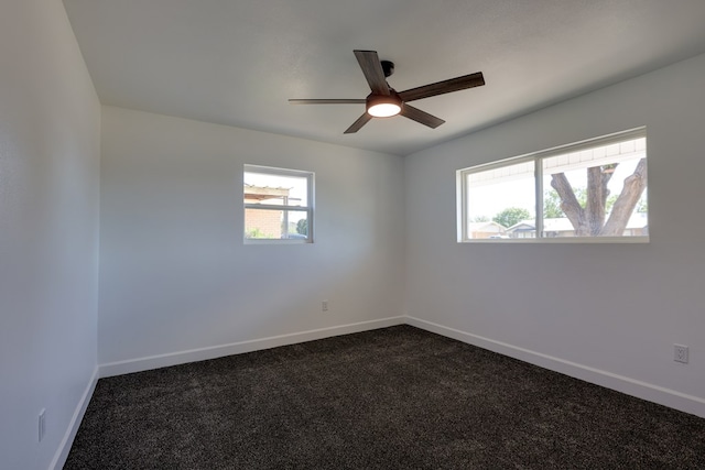 unfurnished room with ceiling fan, baseboards, and dark colored carpet