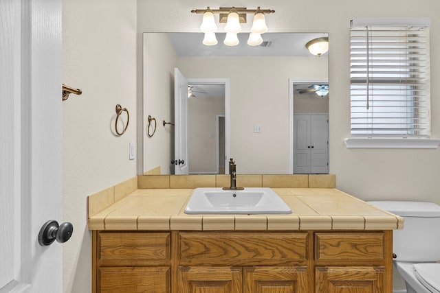 4906 Crista Ln, Midland, TX 79707 - bathroom featuring vanity, plenty of natural light, and ceiling fan