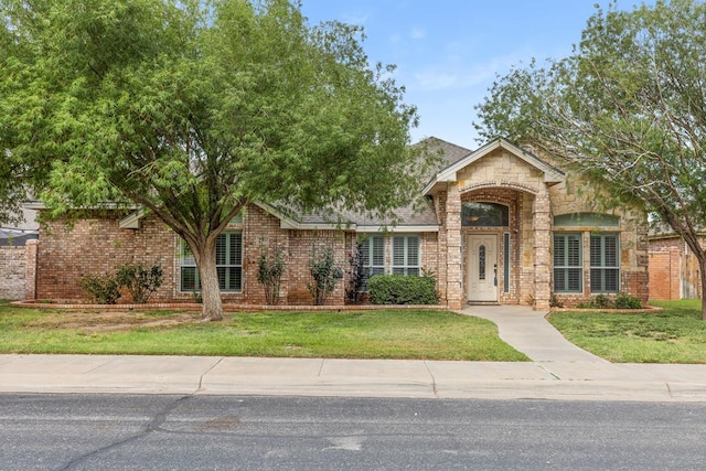4906 Crista Ln, Midland, TX 79707 - view of front of property with a front yard, brick siding, and stone siding