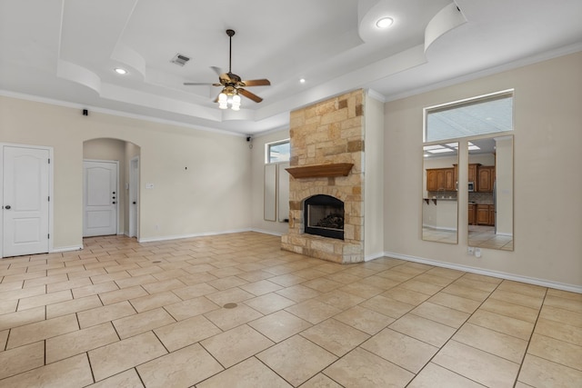 4906 Crista Ln, Midland, TX 79707 - unfurnished living room featuring a tray ceiling, a ceiling fan, a fireplace, arched walkways, and recessed lighting