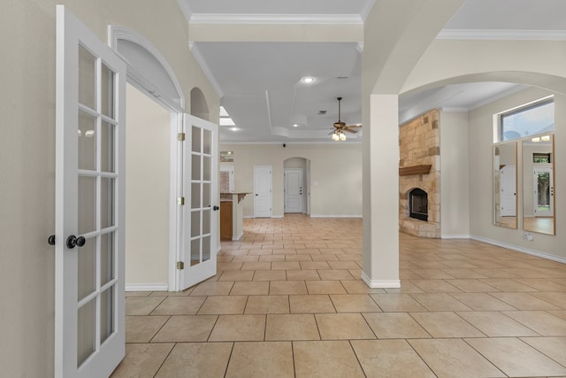 4906 Crista Ln, Midland, TX 79707 - foyer entrance with ceiling fan, a fireplace, french doors, light tile patterned floors, and crown molding