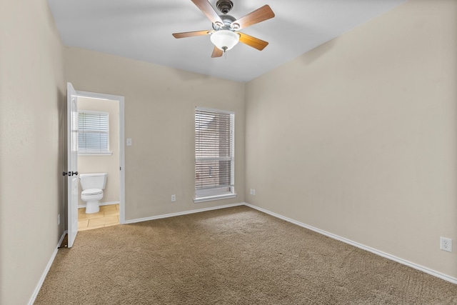4906 Crista Ln, Midland, TX 79707 - unfurnished bedroom with multiple windows, carpet floors, ensuite bath, and a ceiling fan