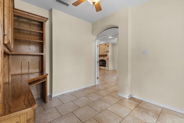 4906 Crista Ln, Midland, TX 79707 - empty room featuring light tile patterned flooring, a ceiling fan, and a large fireplace
