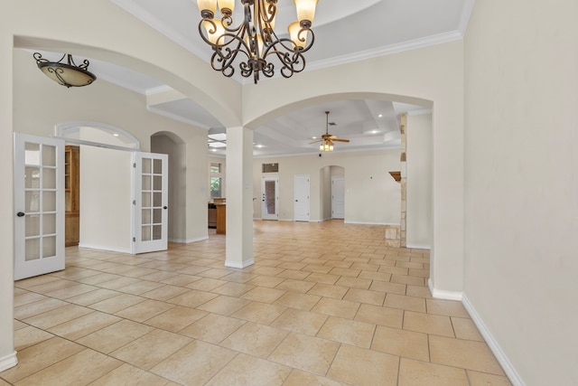 4906 Crista Ln, Midland, TX 79707 - empty room featuring french doors, a ceiling fan, a tray ceiling, crown molding, and arched walkways