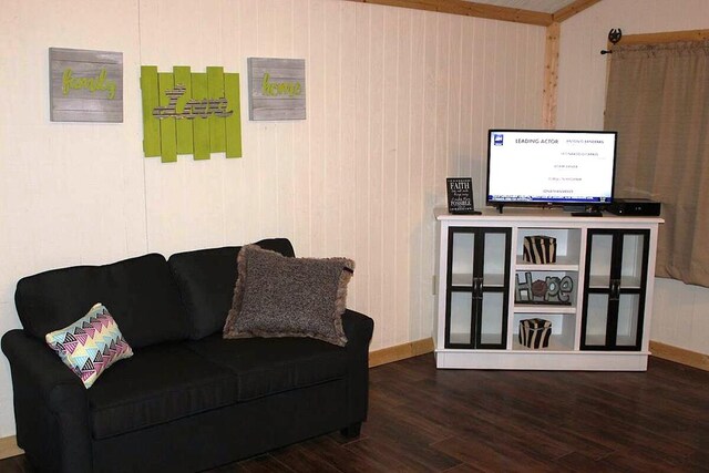 sitting room with baseboards and wood finished floors