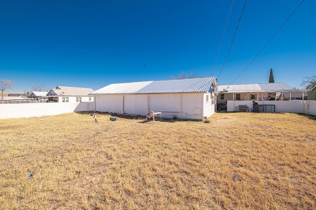 view of yard with an outbuilding, a pole building, and fence