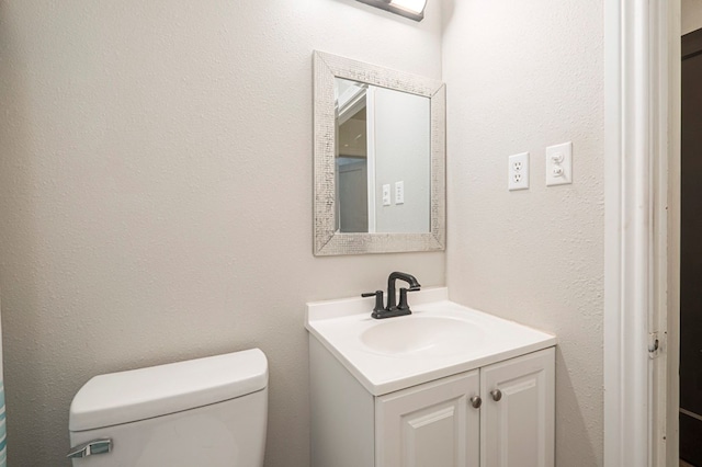 bathroom with toilet and vanity