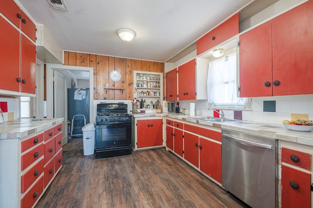 kitchen with black gas stove, red cabinetry, dishwasher, fridge, and a sink