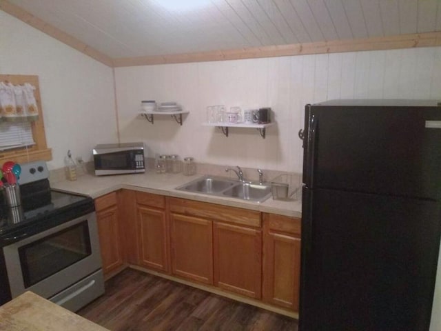 kitchen featuring dark wood-style floors, open shelves, a sink, light countertops, and appliances with stainless steel finishes