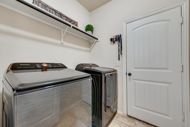 clothes washing area featuring light tile patterned floors, laundry area, and separate washer and dryer