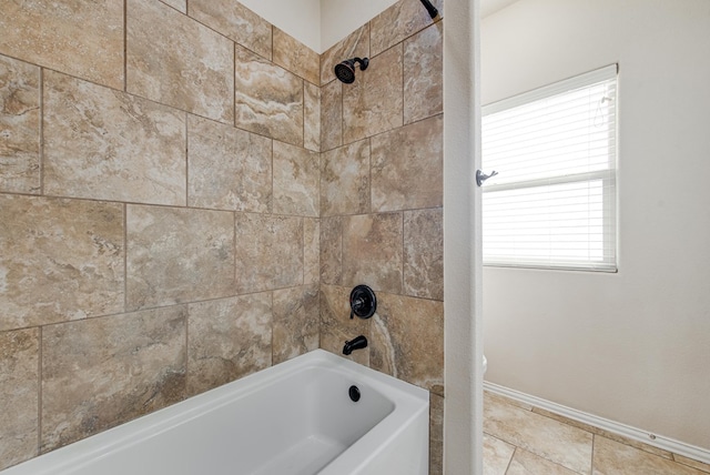 bathroom featuring washtub / shower combination and baseboards