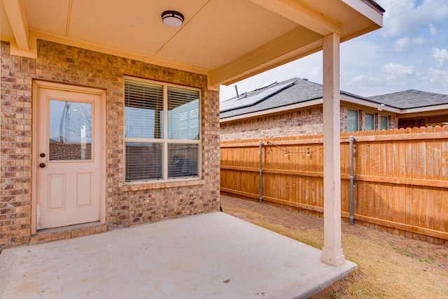 view of patio featuring fence