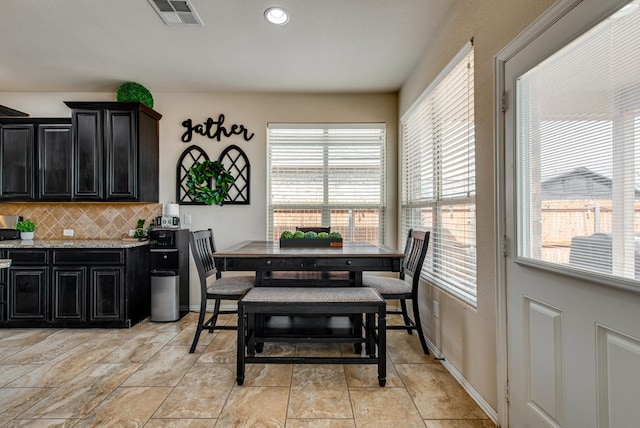 dining space featuring visible vents and baseboards