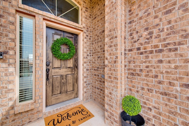 property entrance with brick siding