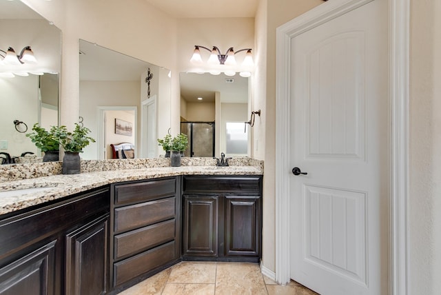 full bathroom with double vanity, a stall shower, and a sink