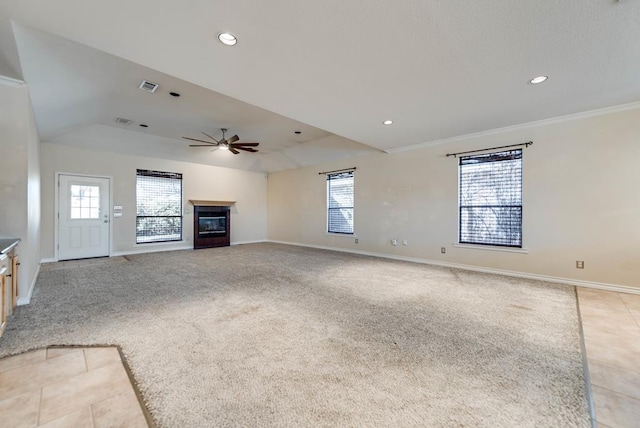 unfurnished living room featuring a glass covered fireplace, a ceiling fan, plenty of natural light, baseboards, and recessed lighting