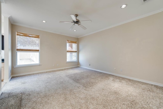 spare room featuring a ceiling fan, light colored carpet, baseboards, recessed lighting, and crown molding