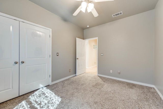 unfurnished bedroom with carpet floors, baseboards, ceiling fan, and a closet