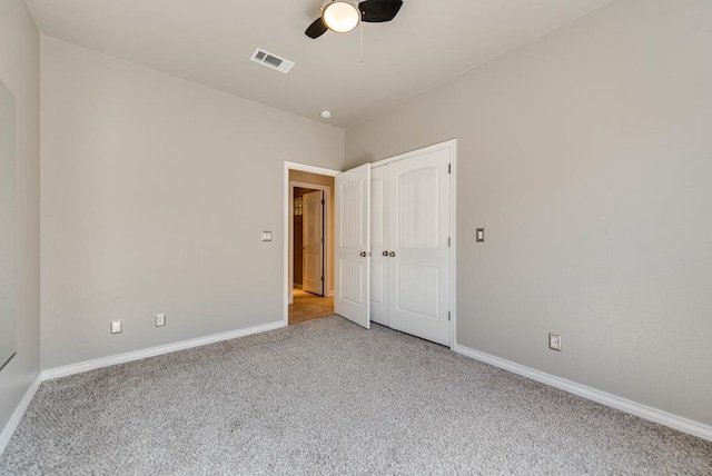 unfurnished bedroom with carpet, baseboards, a closet, and ceiling fan