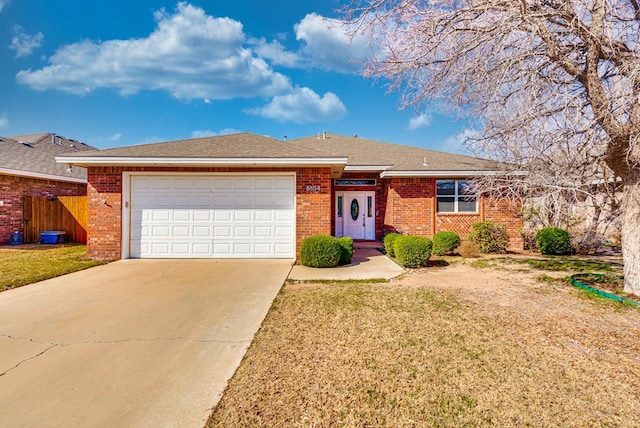 single story home featuring brick siding, concrete driveway, and an attached garage