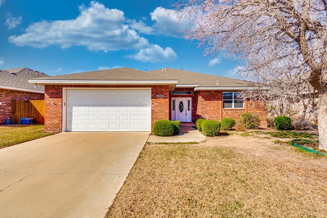 single story home featuring brick siding, driveway, and an attached garage