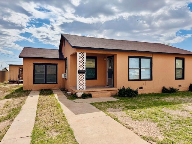 bungalow-style home with roof with shingles, stucco siding, cooling unit, and crawl space