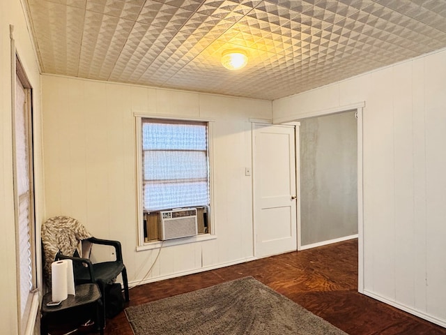 living area featuring cooling unit and wood finished floors