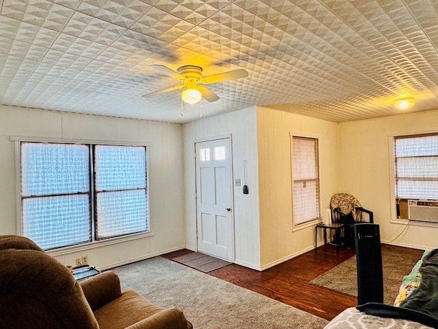 living room featuring a ceiling fan and plenty of natural light