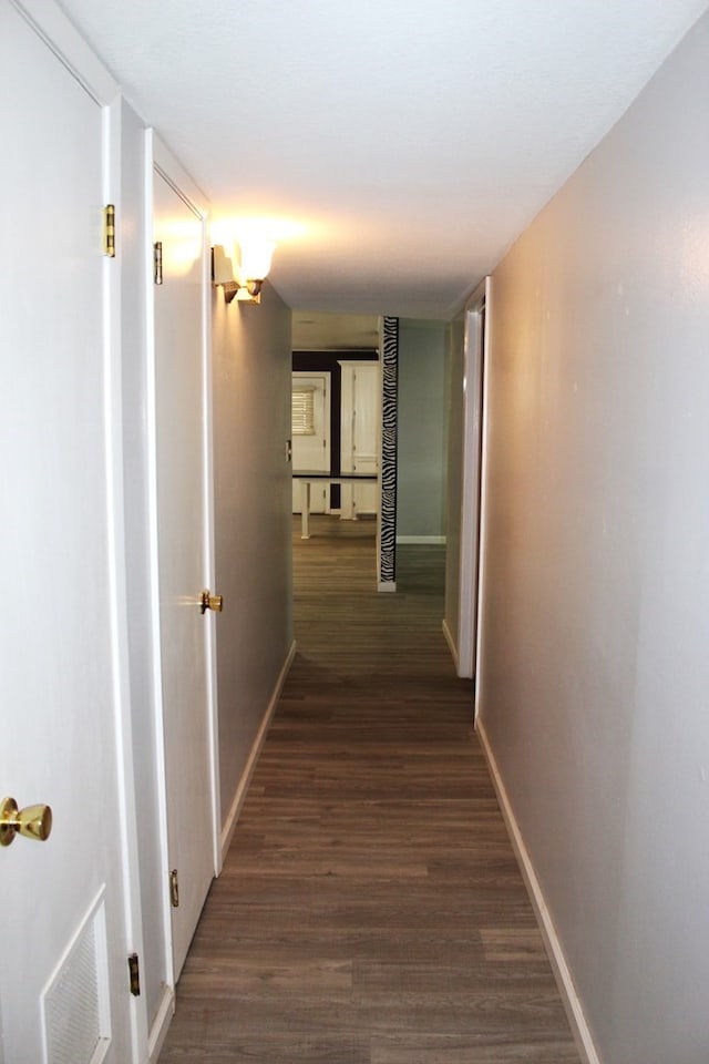 hallway featuring dark hardwood / wood-style flooring