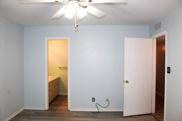 bedroom featuring ensuite bathroom, ceiling fan, and dark wood-type flooring