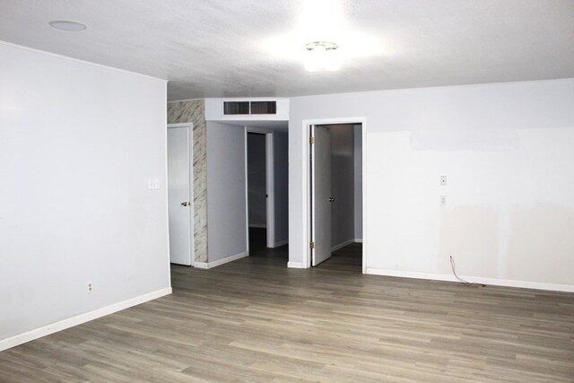 unfurnished room with hardwood / wood-style flooring