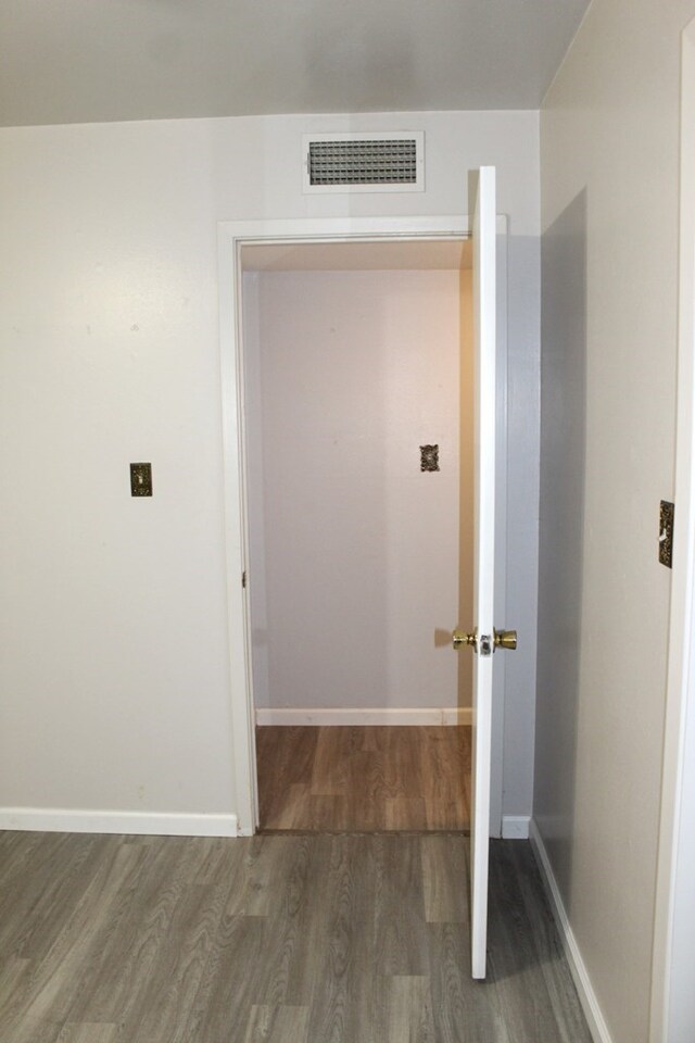 hallway featuring dark hardwood / wood-style flooring