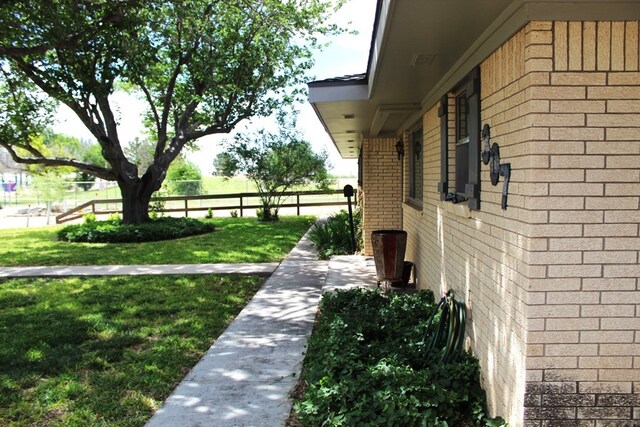 view of side of home with a yard