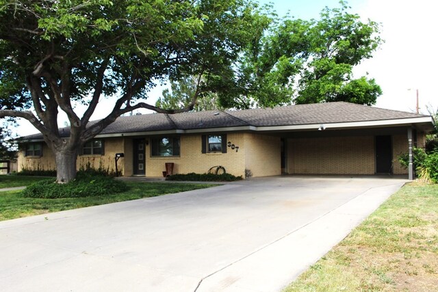 ranch-style home with a front lawn and a carport