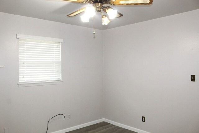 spare room featuring ceiling fan and dark wood-type flooring