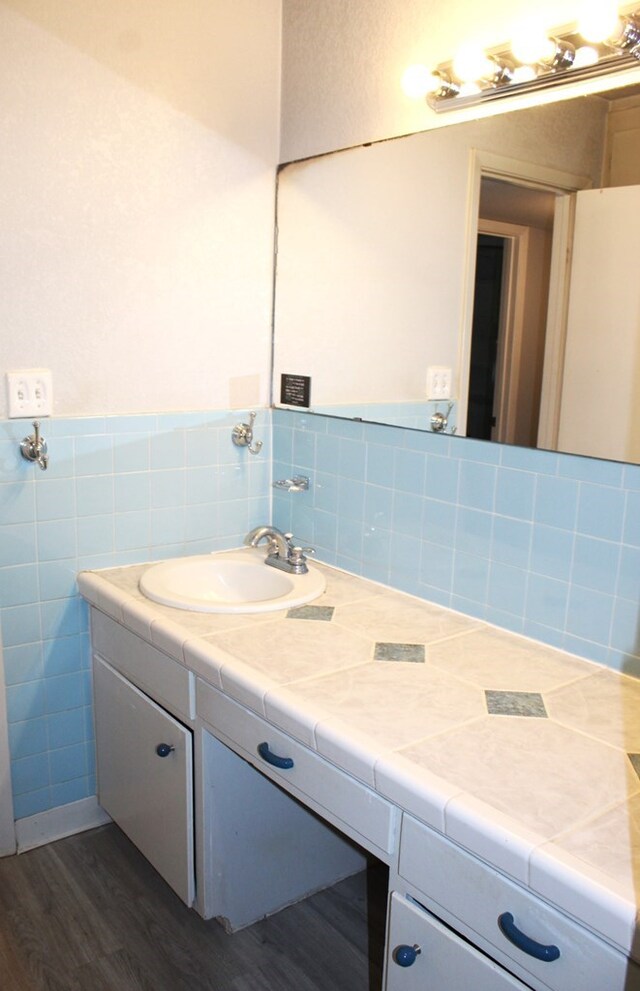 bathroom with vanity and hardwood / wood-style flooring