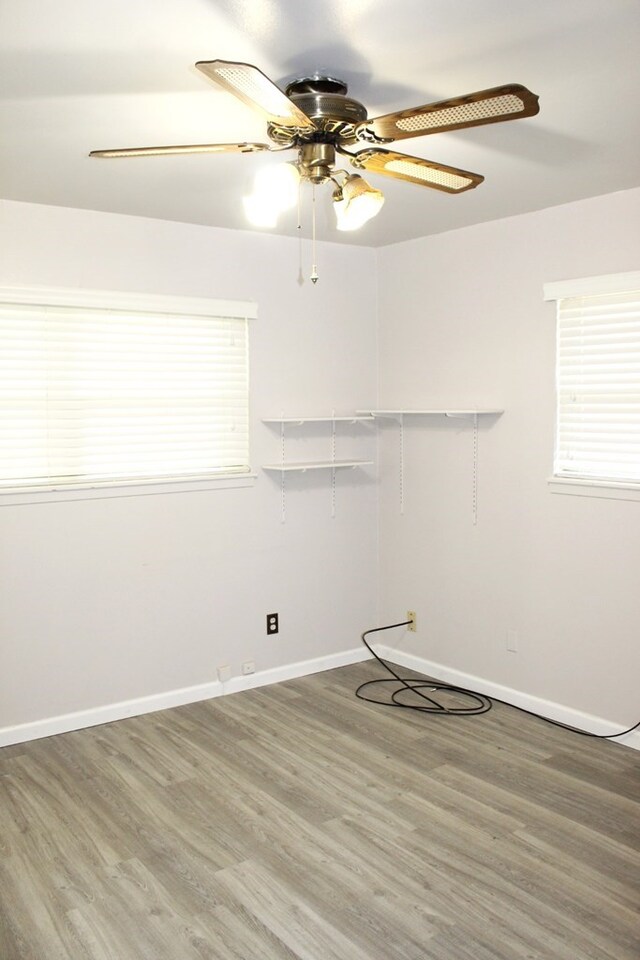 unfurnished room featuring hardwood / wood-style flooring and ceiling fan