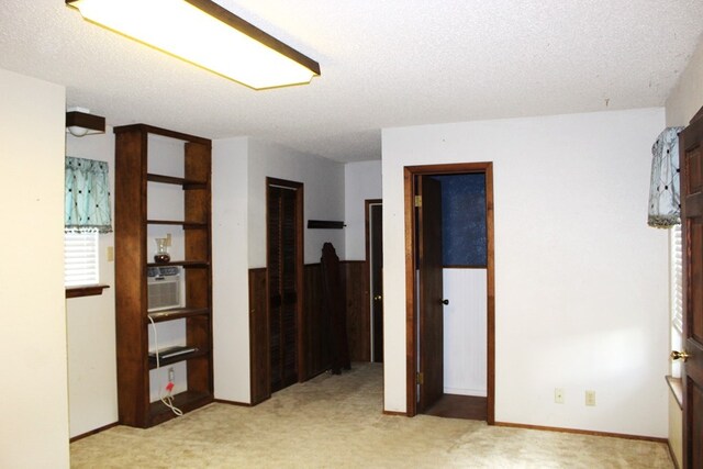 carpeted spare room featuring a textured ceiling