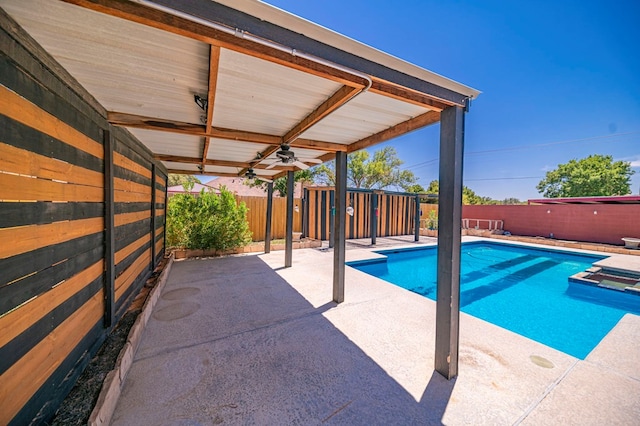 view of pool with ceiling fan and a patio area