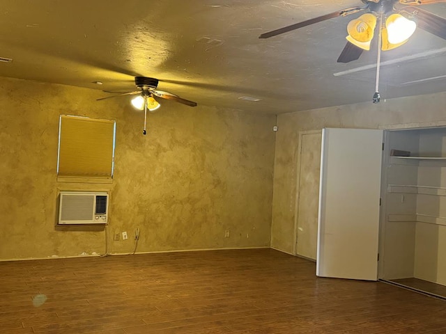 empty room with wood-type flooring and a wall unit AC