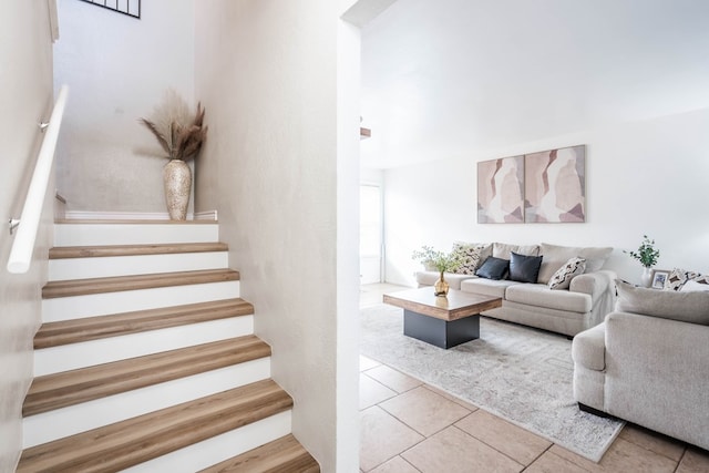 stairway featuring tile patterned flooring