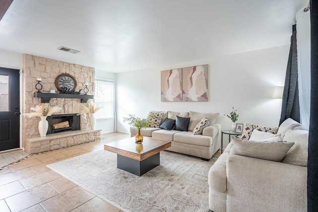 tiled living room with a fireplace and visible vents