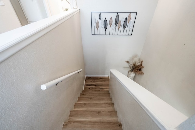 staircase with wood finished floors