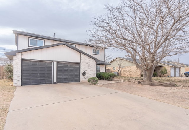 view of front of property featuring concrete driveway, brick siding, and an attached garage