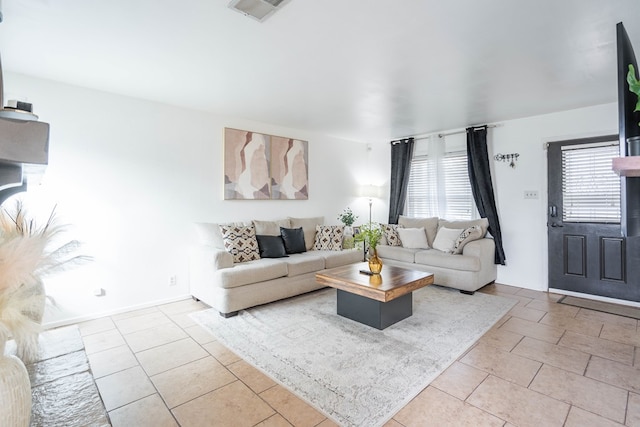 tiled living room featuring visible vents