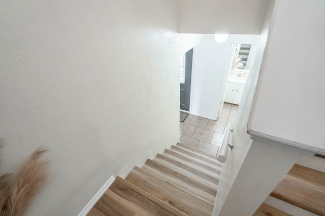 stairs with wood finished floors