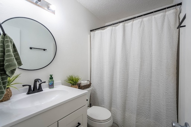 full bathroom featuring a textured ceiling, vanity, and toilet